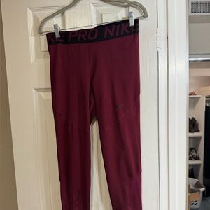 Nike Dri-Fit burgundy pro Nike leggings. Elastic waist. Mesh inserts on legs.